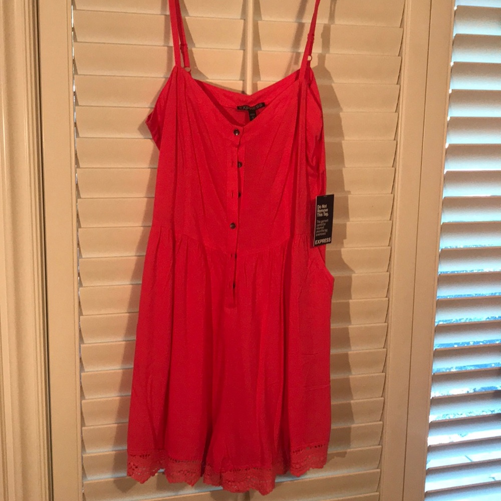 Pink button up romper with pockets